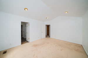 Unfurnished bedroom with carpet and ensuite bathroom