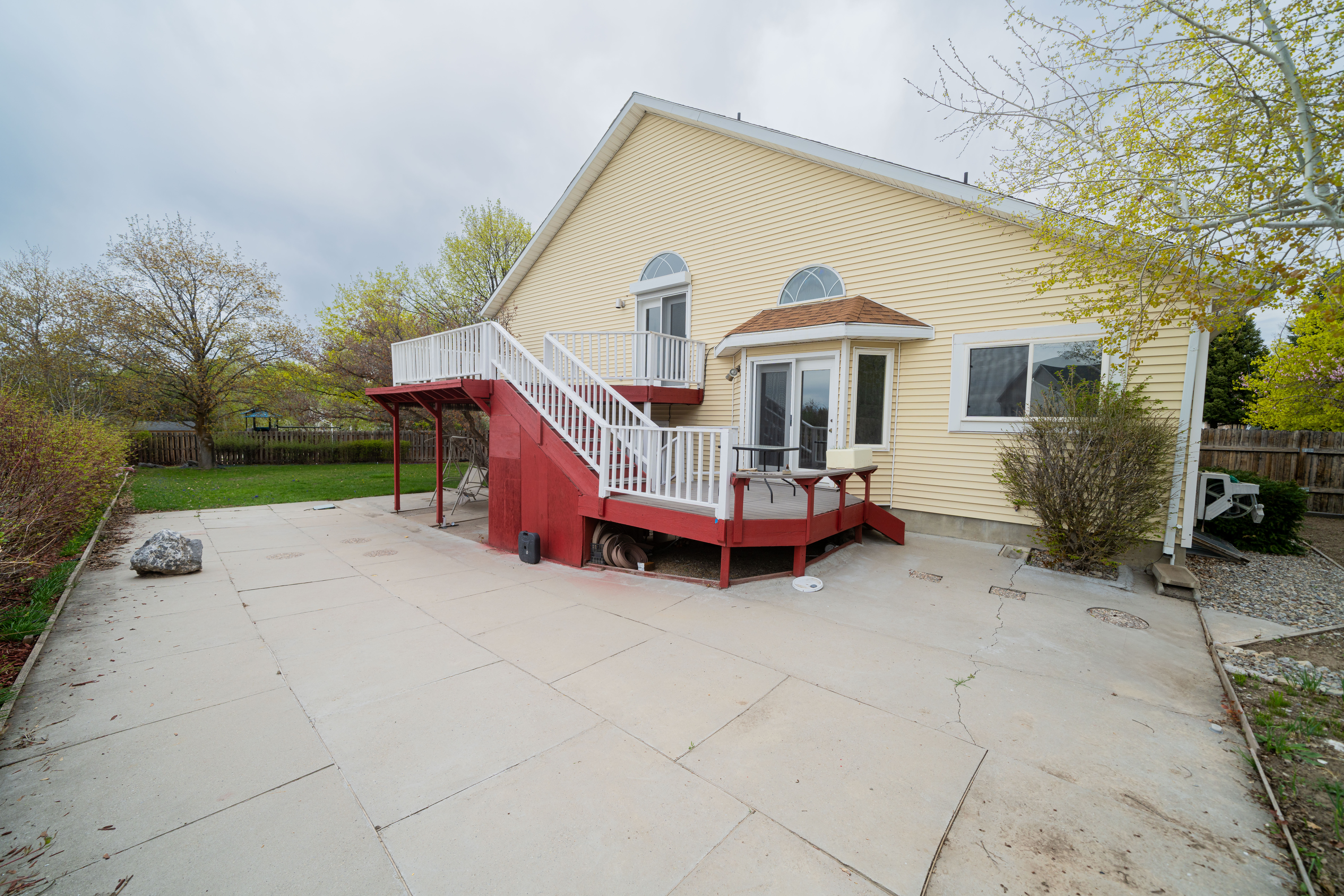 Back of house featuring a deck and a patio
