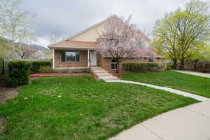 View of front of home with brick siding and covered porch
