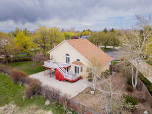 Rear view of property with a fenced backyard, a wooden deck, and a chimney