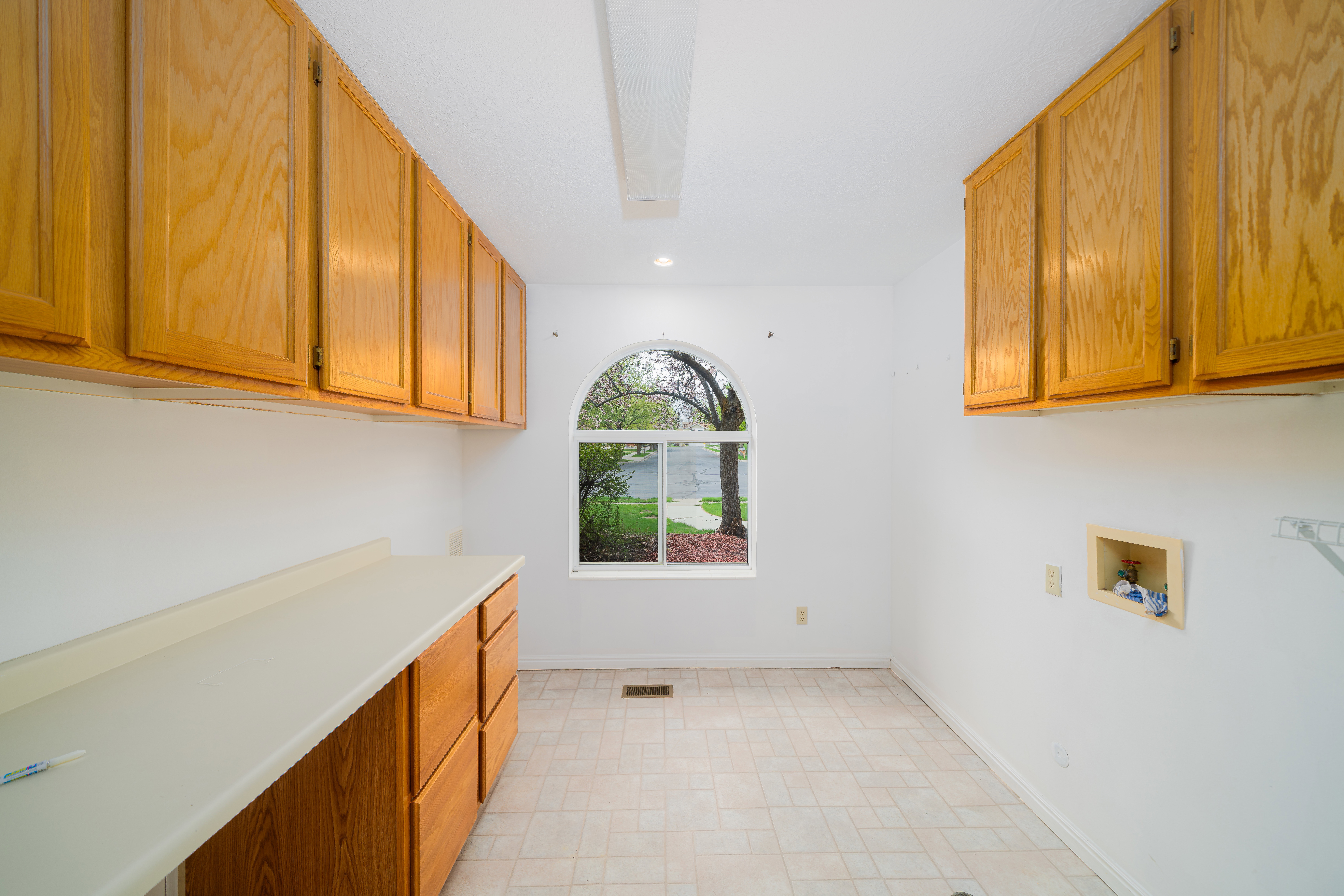 Laundry room featuring cabinet space, washer hookup, and recessed lighting