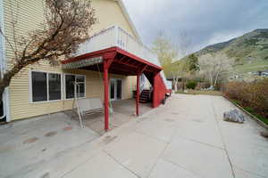 View of side of home featuring a patio and a mountain view