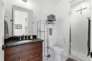 Bathroom featuring a stall shower, vanity, and light tile patterned floors