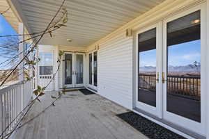 Wooden deck with french doors and a mountain view