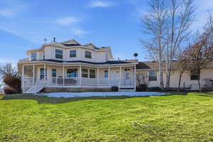 View of front of house featuring a large porch and a front yard