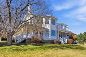 View of front of home with a front yard and a porch