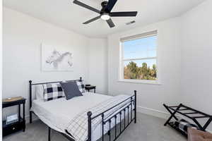 Bedroom with light carpet and ceiling fan
