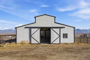 View of barn with a mountain view