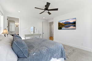 Bedroom featuring connected bathroom, carpet, ceiling fan, and recessed lighting