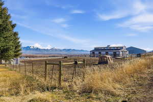 View of yard with a rural view, a mountain view, and an outdoor structure