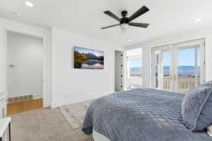 Bedroom with light colored carpet, ceiling fan, recessed lighting, and access to exterior