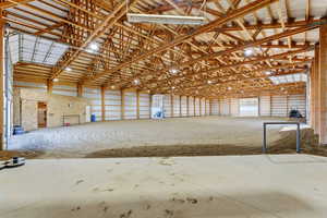 Miscellaneous room featuring a high ceiling and metal wall