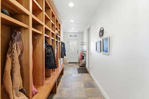 Mudroom with stone tile floors and recessed lighting