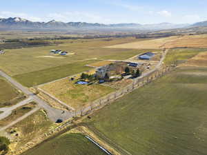 Aerial view of sparsely populated area with farmland and a mountain backdrop
