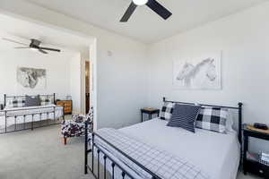 Bedroom featuring light carpet and a ceiling fan