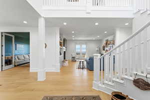 Foyer entrance with light wood-type flooring and recessed lighting