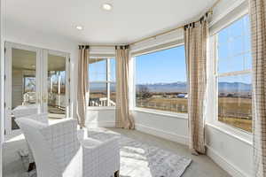 Sunroom with a mountain view and french doors