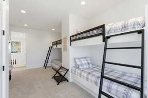 Bedroom with recessed lighting and light carpet