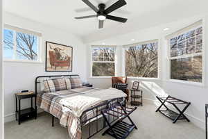 Bedroom with light carpet, a ceiling fan, multiple windows, and recessed lighting