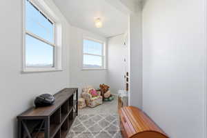 Doorway to outside featuring carpet flooring