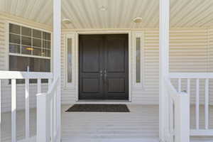 Property entrance featuring covered porch