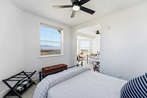 Bedroom with carpet flooring, ceiling fan, and a mountain view