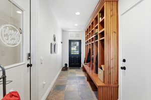Mudroom with stone tile flooring and recessed lighting