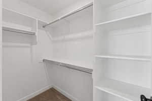 Walk in closet with dark carpet