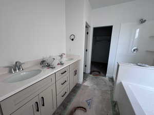 Bathroom with double vanity and a bath