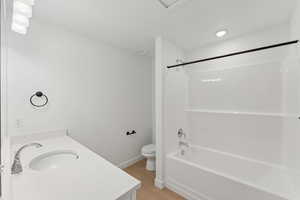 Full bathroom featuring vanity, bathtub / shower combination, and light wood-type flooring