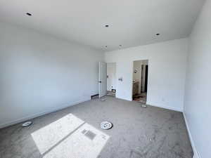 Unfurnished bedroom featuring carpet and ensuite bathroom