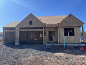 View of front of home featuring a porch, a garage, and board and batten siding