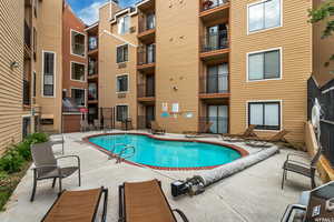 Community pool with a patio