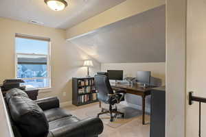 Office space featuring light colored carpet and baseboards
