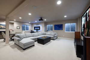 Living area featuring light colored carpet and recessed lighting