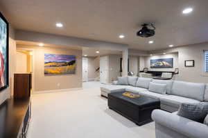 Carpeted living room with recessed lighting