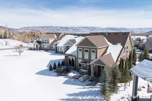 Snowy aerial view with a residential view and a mountain view
