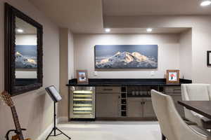Home office with wine cooler, recessed lighting, and light carpet