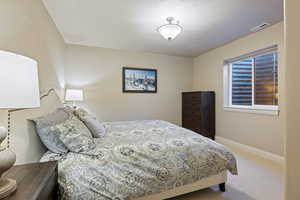 Bedroom featuring carpet flooring and a textured ceiling