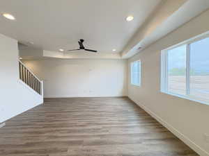Spare room featuring light wood-style floors, a ceiling fan, and recessed lighting