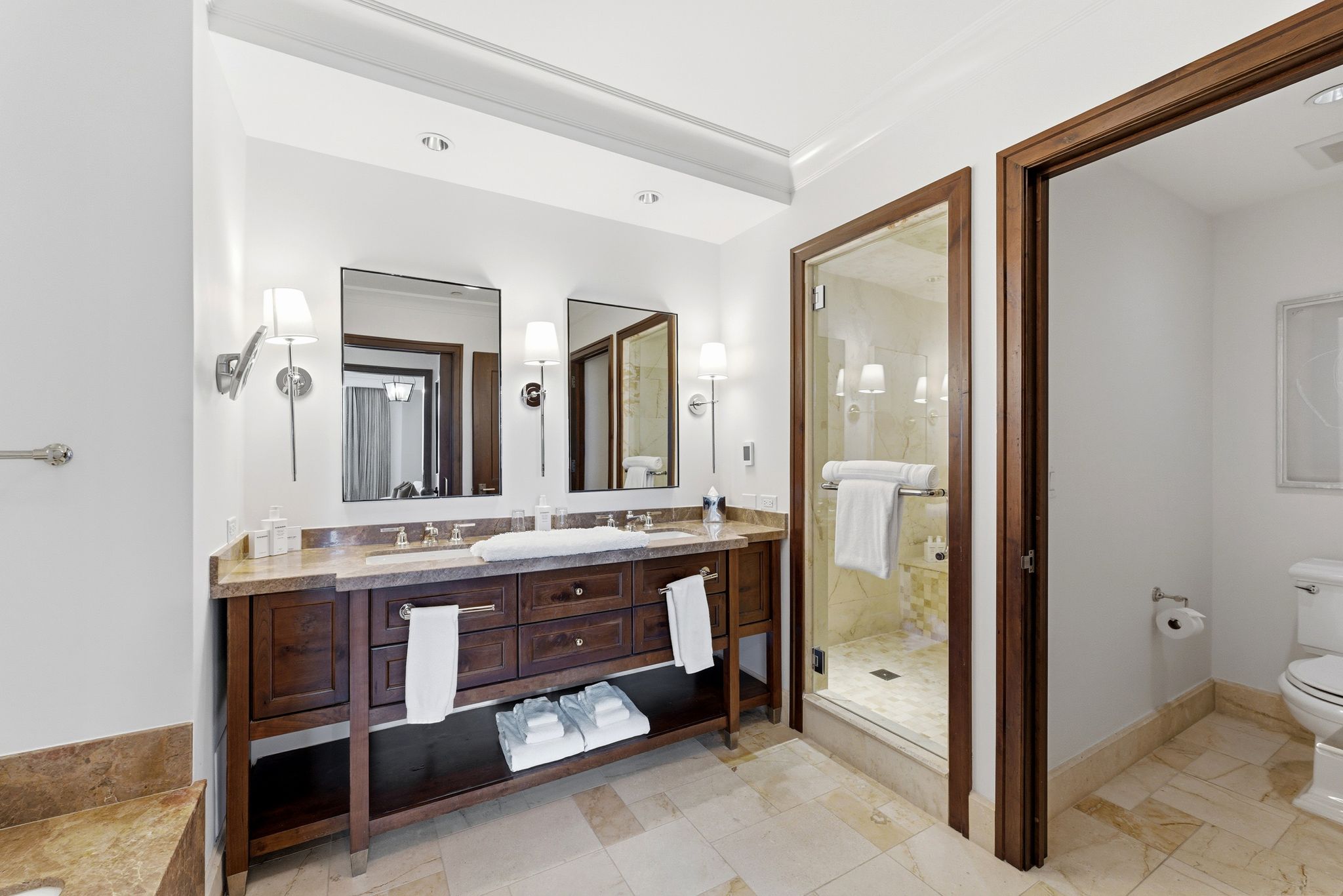 Bathroom featuring double vanity and a shower stall