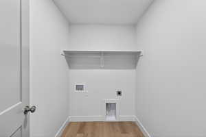 Laundry room with electric dryer hookup, light wood-style flooring, and washer hookup