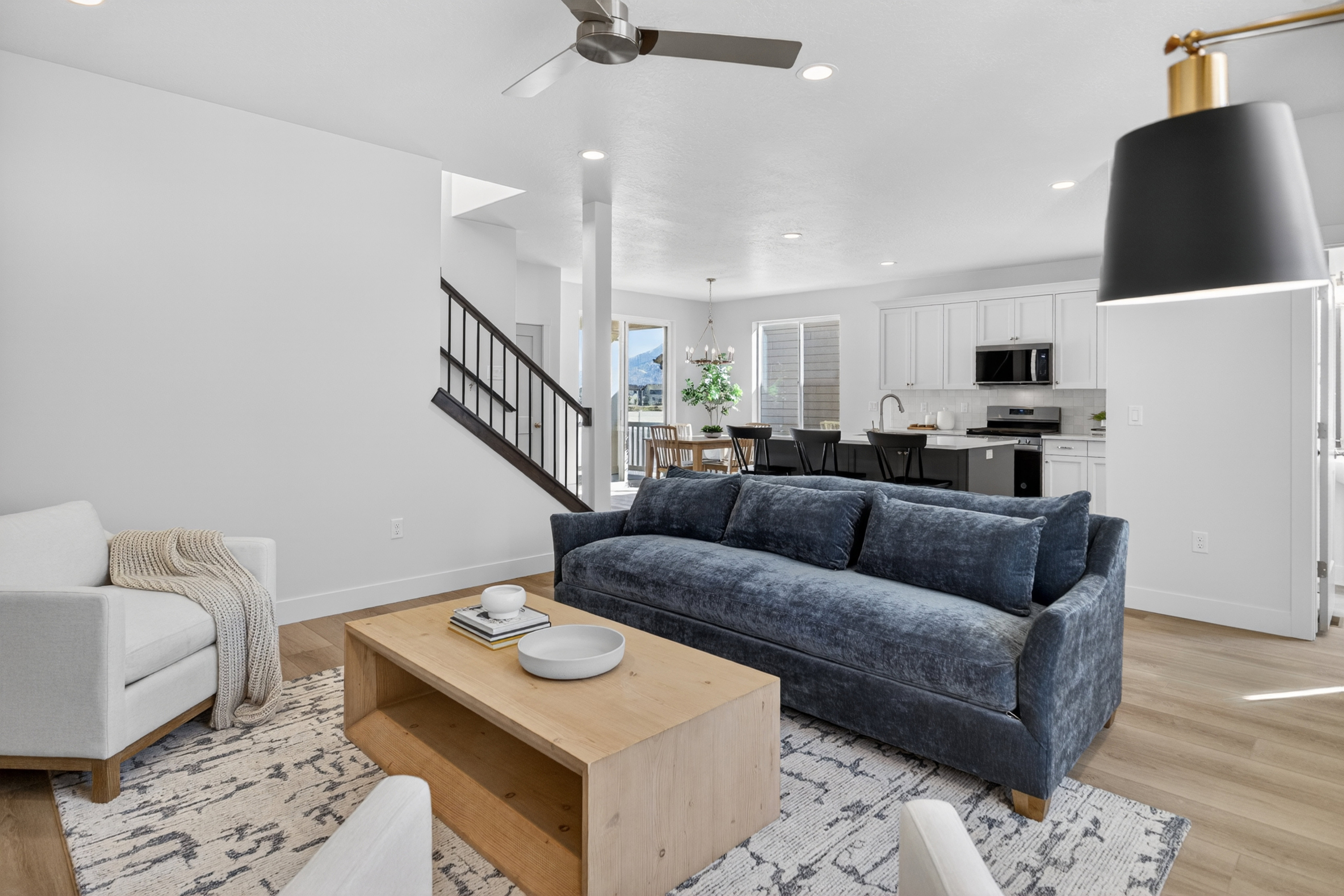 Open-concept living space featuring wood-finish flooring, recessed lighting, and a modern ceiling fan