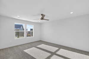 Empty room featuring light carpet, a ceiling fan, and recessed lighting