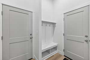 Mudroom with light wood finished floors and baseboards