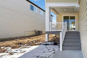 View of side of home with a wooden deck and a cooling unit