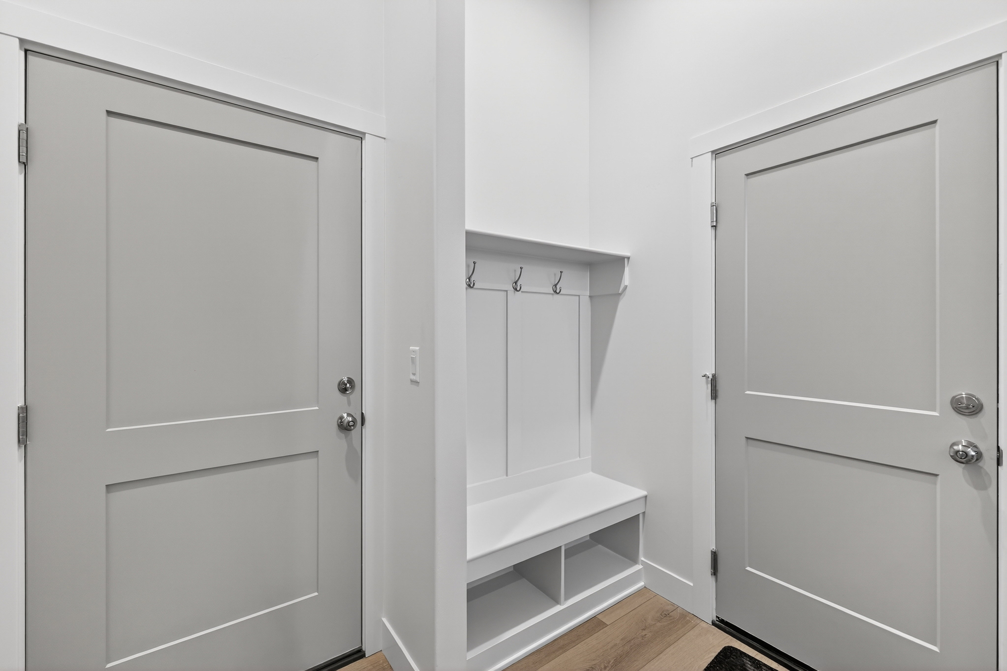 Built-in mudroom bench with storage cubbies and coat hooks
