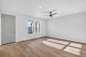 Empty room featuring ceiling fan, recessed lighting, and light wood-style floors