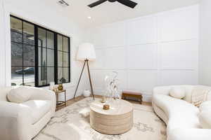 Sitting room featuring a decorative wall, wood finished floors, a ceiling fan, and recessed lighting
