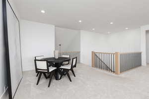 Dining room featuring recessed lighting and light carpet